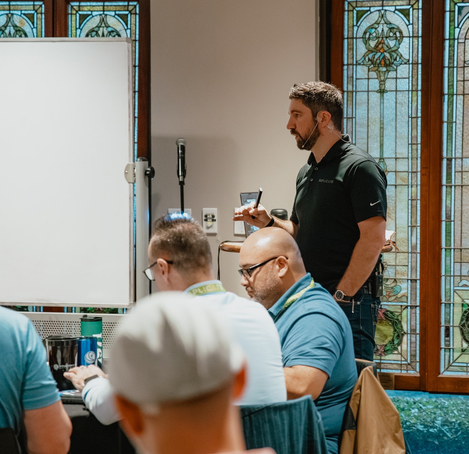 brad teaching with stainglass and whiteboard square